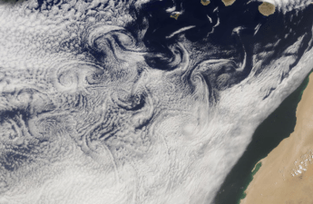 A cloud-filled sky, rugged islands, and turbulent air joined to create fanciful designs in the atmosphere